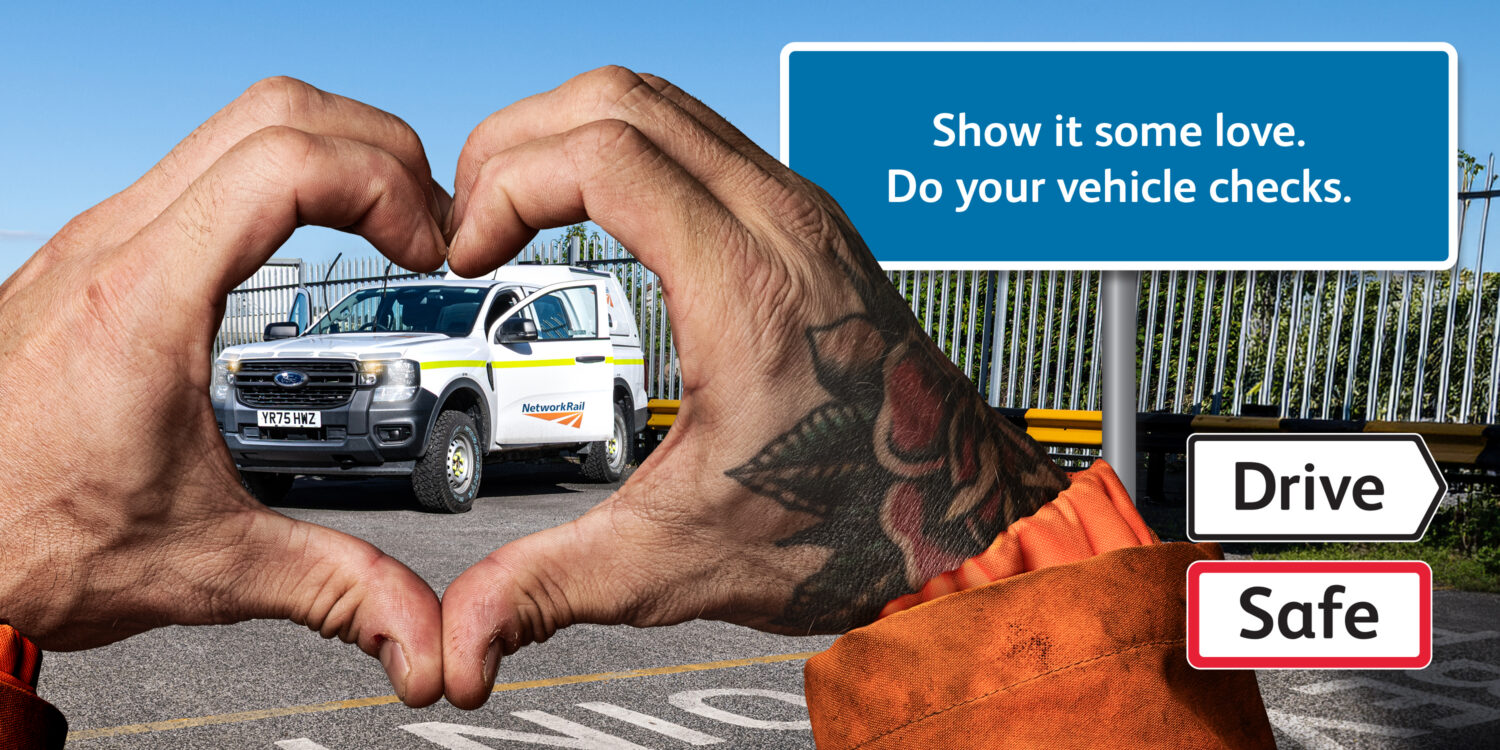 Two hands forming a heart shape, through which we see a Network rail vehicle. A road sign says: 'Show it some love, Do your vehicle checks'. The Drive Safe logo appears in the corner.